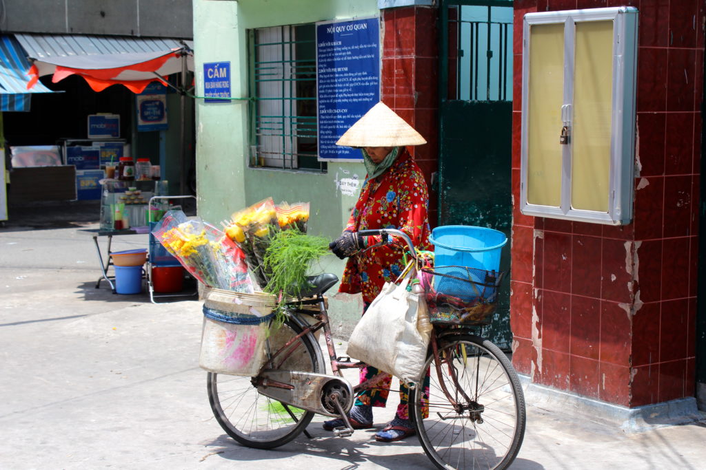 A local woman selling flowers from her bicycle near a market in District 10. 