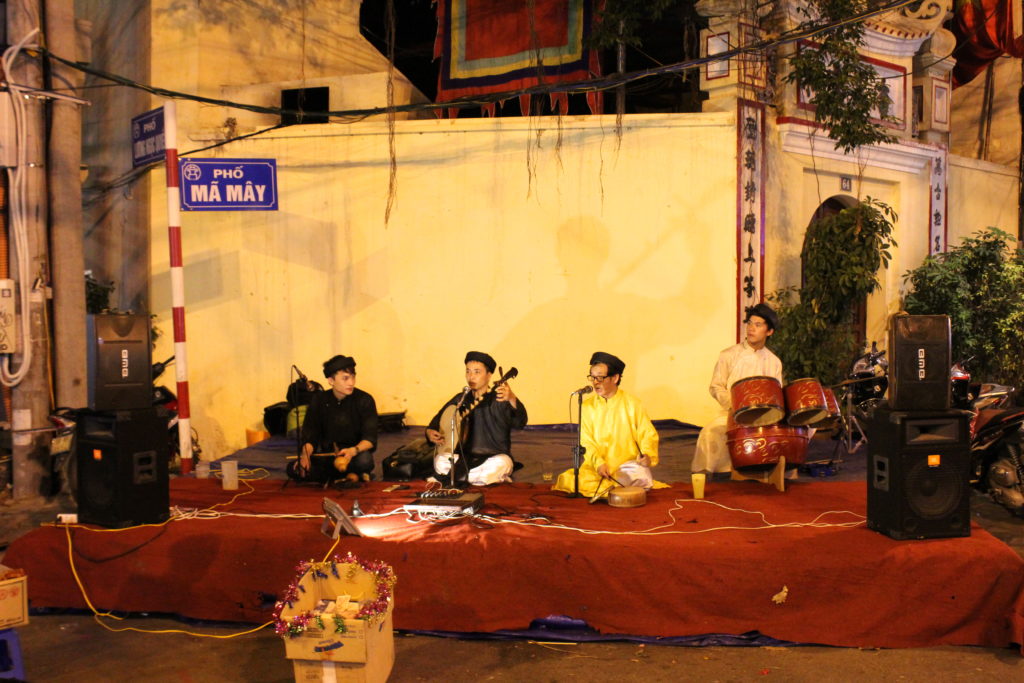 Traditional Vietnamese musicians play in the streets of the Old Quarter.