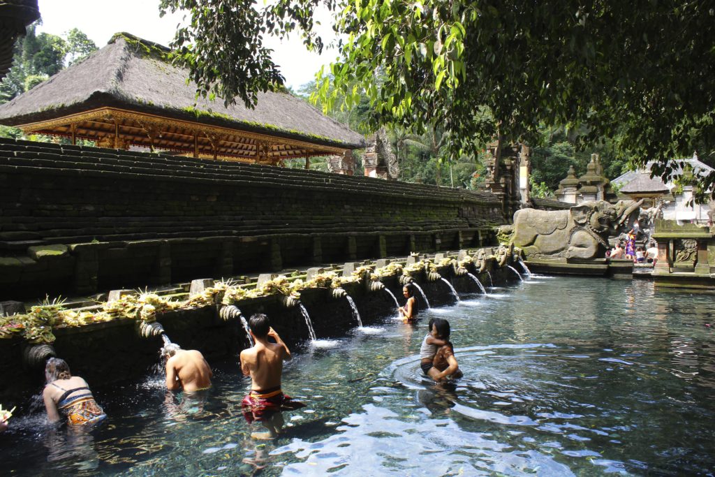 Balinese worshipers seek the cleansing powers of the holy spring water.