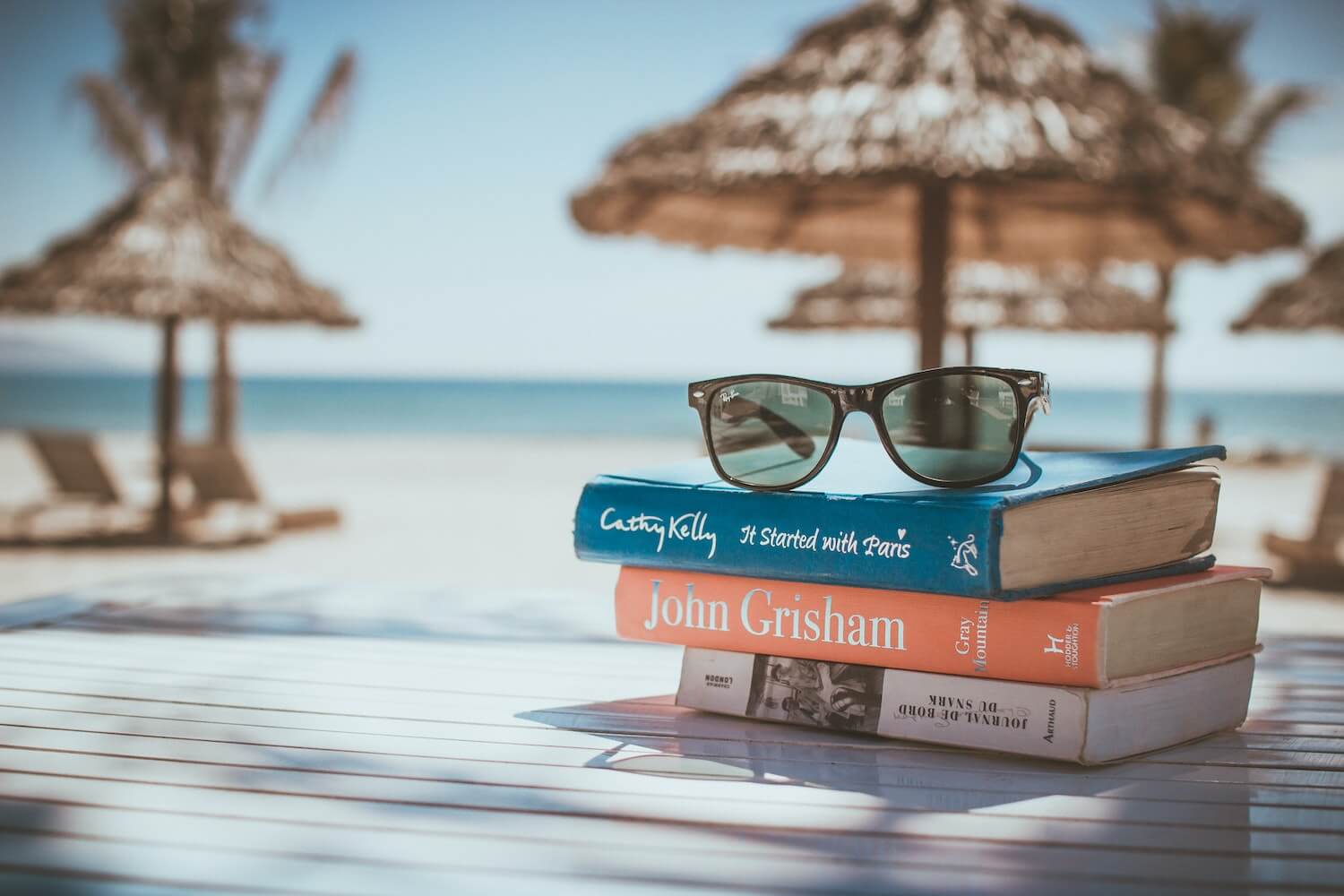 Audible FREE 30-day trial, 5 Reasons Why an Audible Subscription is worth it for Travelers, FREE audible subscription, books by the beach, carrying books